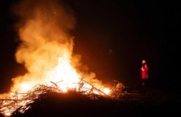 голяма огнена клада и малка фигура до нея